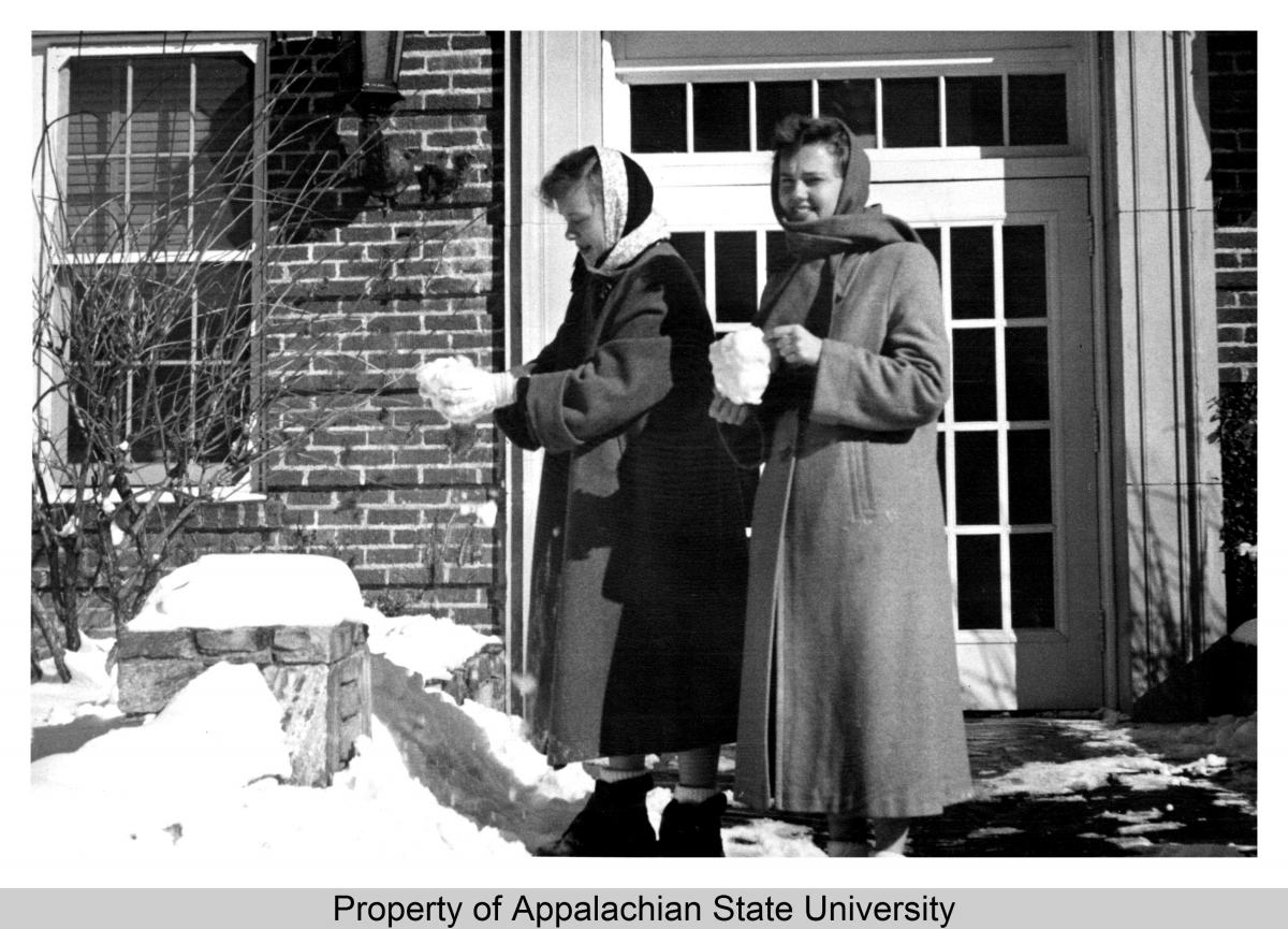 Description This image shows two students making snowballs after a snowfall at Appalachian State Teachers College (1929-1967) in the 1950s. Two women in winter coats can be seen standing outside what is likely Watauga County Hospital, built 1932 and later renamed Founders Hall, holding balls of snow.