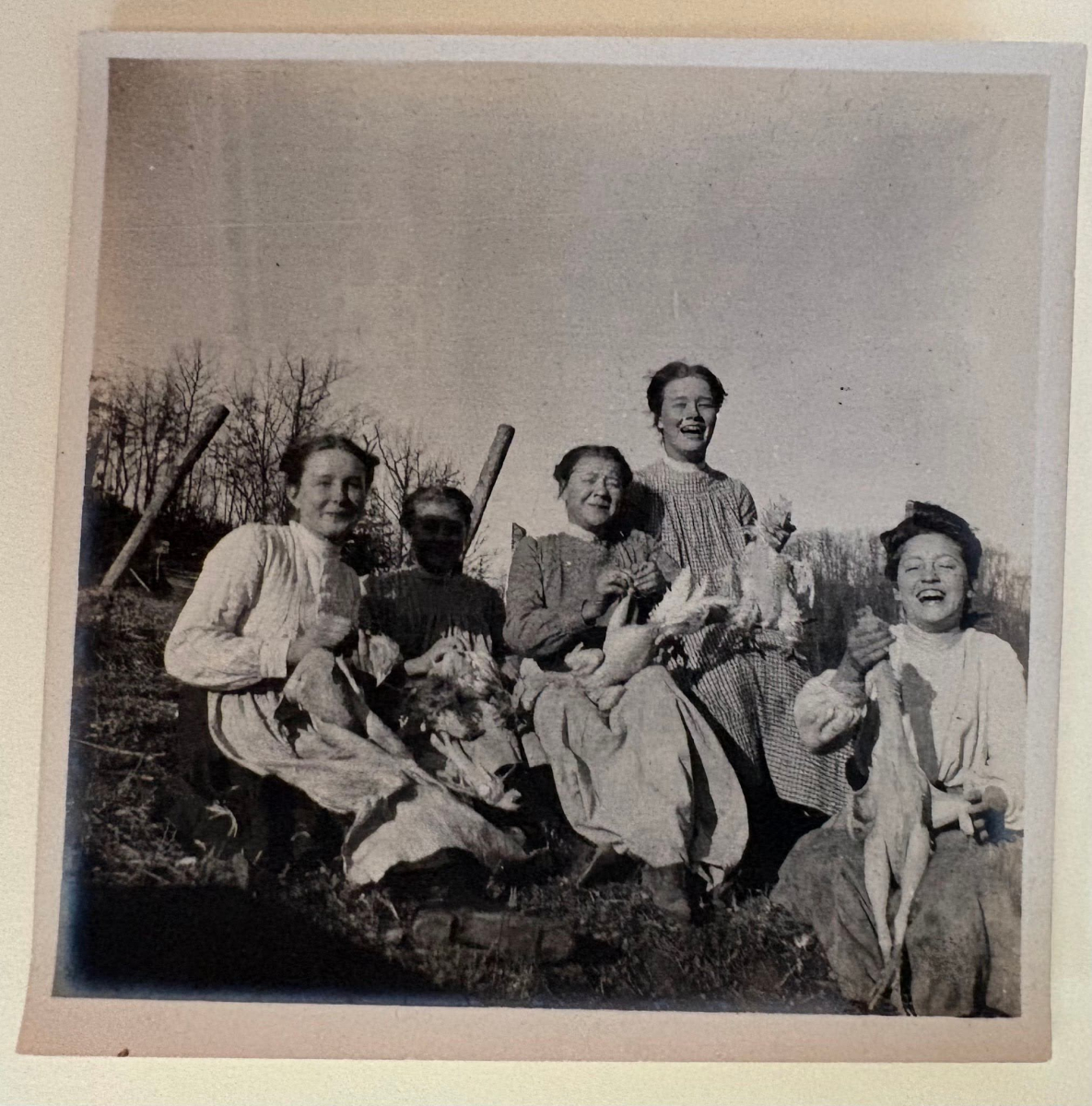 Group of community members working together to prepare chickens.