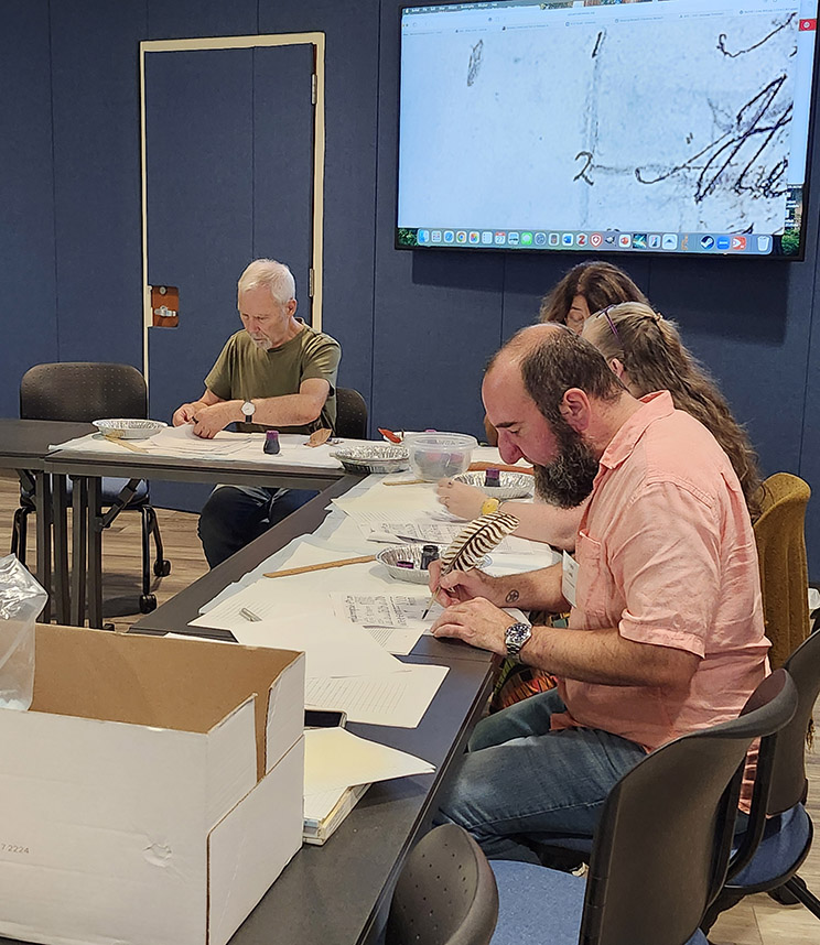 Participants trying a handwriting exercise in insular scripts