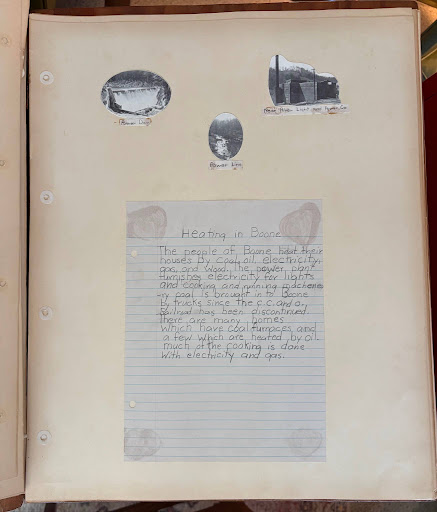 Picture of a handwritten page from a circa 1940 school class history describing the use of  coal, oil, gas, wood, and electricity for heating.