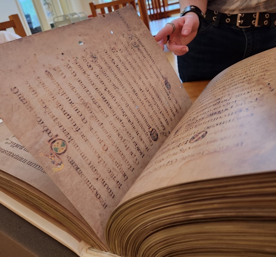 A visitor thumbs through the facsimile Book of Kells