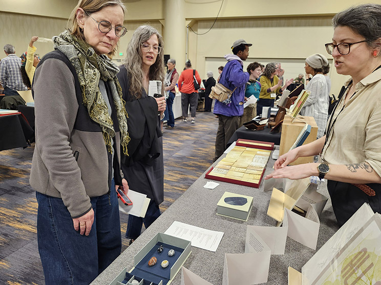Jessica Greenfield speaks with visitors about her artists' books