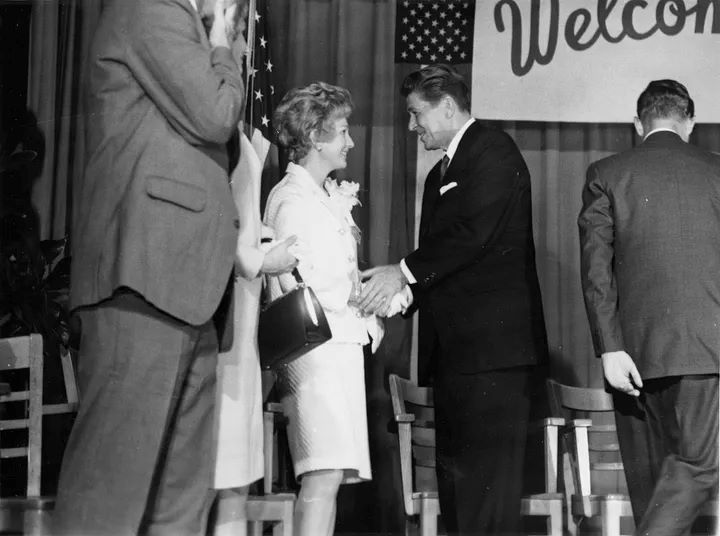 Louise Broyhill shakes hands with Ronald Reagan