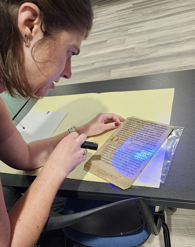 Helen Davies uses infrared light to examine a manuscript leaf
