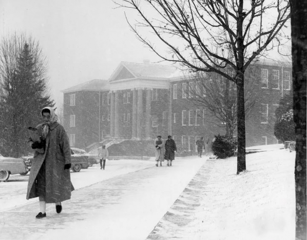 Students braving the snow and wind in 1965. The old Administration Building is in the background.