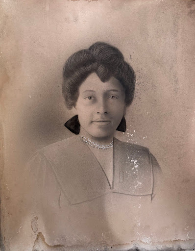 A portrait of a young African American women, with fancy attire and jewelry