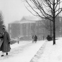 Students braving the snow and wind in 1965. The old Administration Building is in the background.