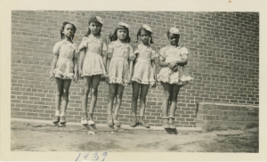 Lincoln Heights School - May Day, 1939. The image above shows five girls in identical dresses and hats pose for a photo. 