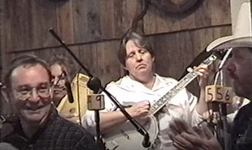 Still image of John Turner (left) and the Old Time Tradition band in the background.